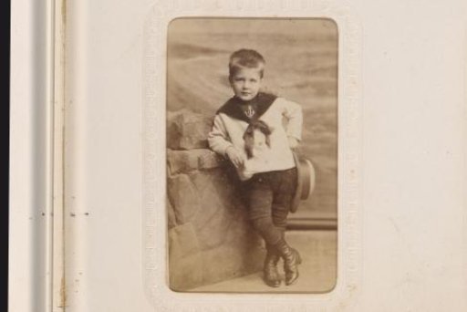 Portrait of Two Children on and Beside a Chair