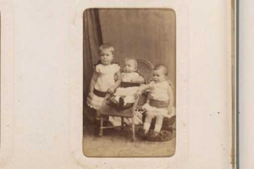 Portrait of a Sitting Baby in a White Dress