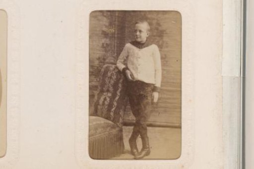 Portrait of a Sitting Baby on a Chair and a Standing Boy
