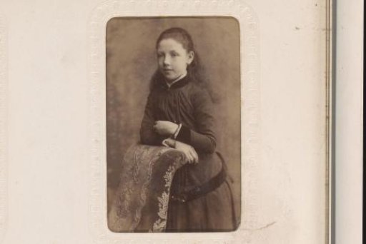 Portrait of a Girl Standing Beside a Fence