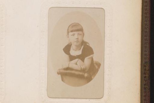 Portrait of a girl, kneeling on a chair
