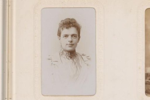 Portrait of a young woman in a high-closed dress