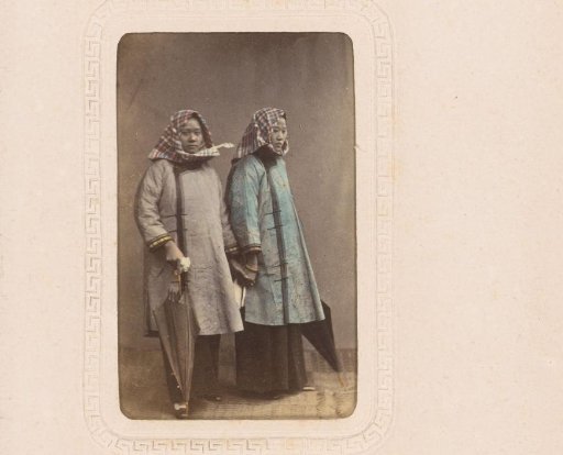 Portrait of two women with umbrellas