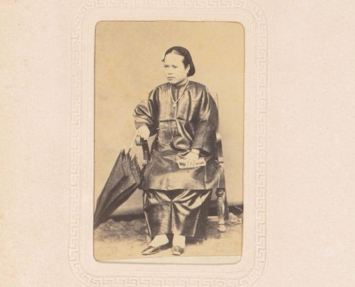 Portrait of a seated woman with an umbrella