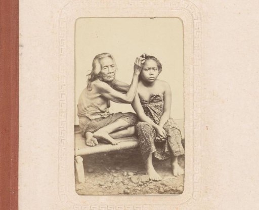 Indonesian old woman picking lice from a girl