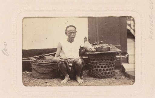 Portrait of an Indonesian butcher with a pig's head