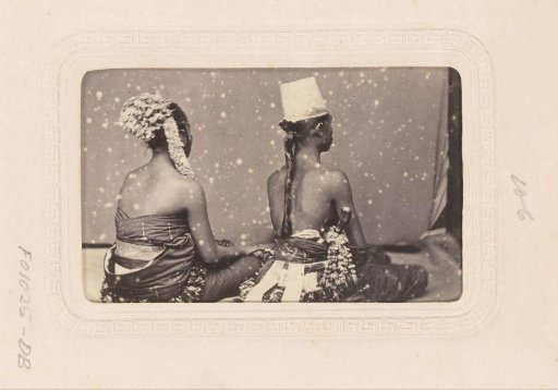 Two Indonesian dancers, seen from behind