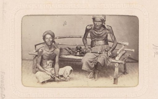 Portrait of two Indonesian men smoking opium