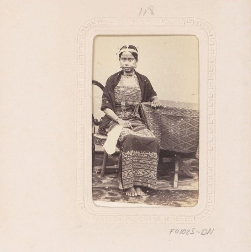 Portrait of a seated young Indonesian woman with a headband