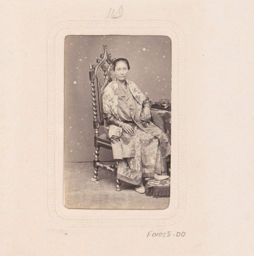 Portrait of an Indonesian woman on a Gothic chair
