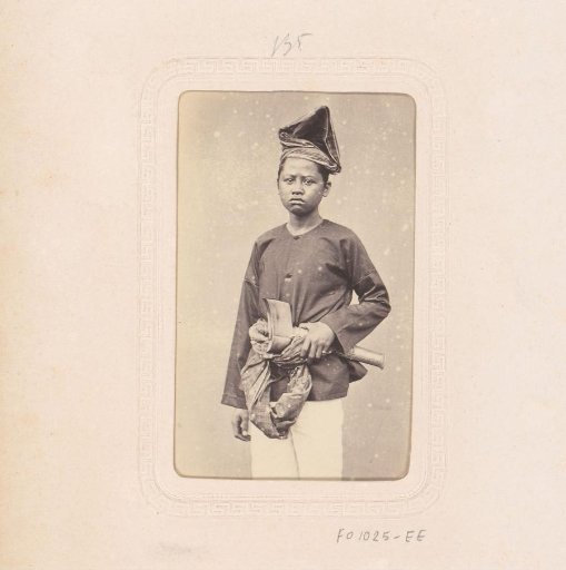 Portrait of an Indonesian boy with an axe