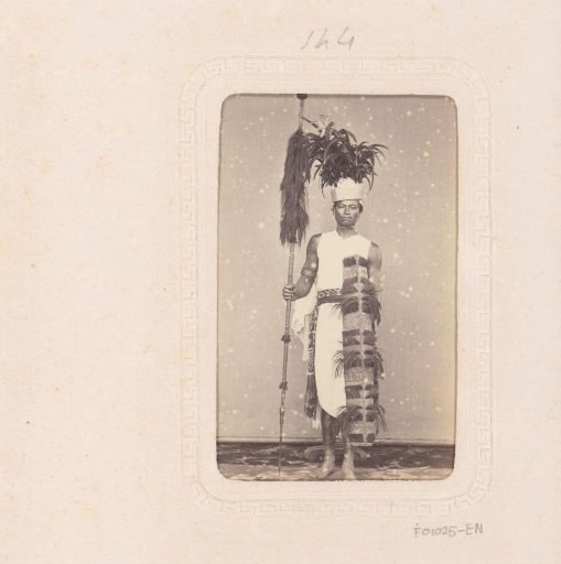Portrait of an Indonesian man with a spear and headdress