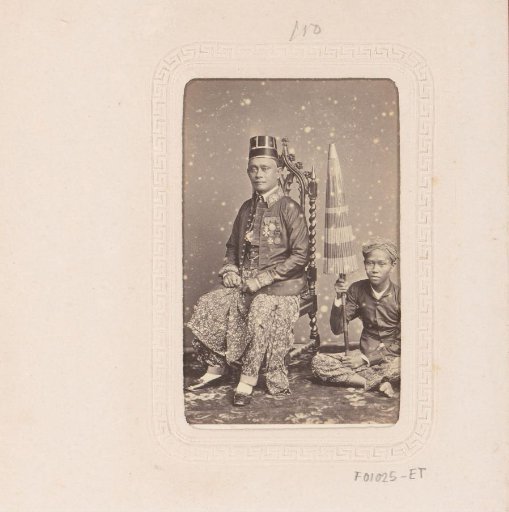 Portrait of an Indonesian man with a boy holding a parasol