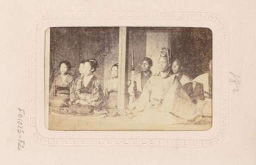 Japanese men and women, seated during a ritual