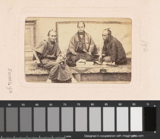 Portrait of three Japanese men with an abacus and book