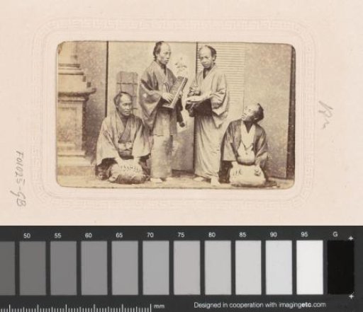 Portrait of four Japanese men with an abacus