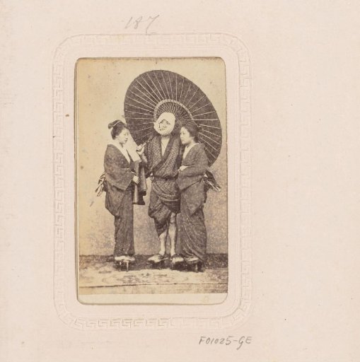 Portrait of two Japanese women and a man with a parasol