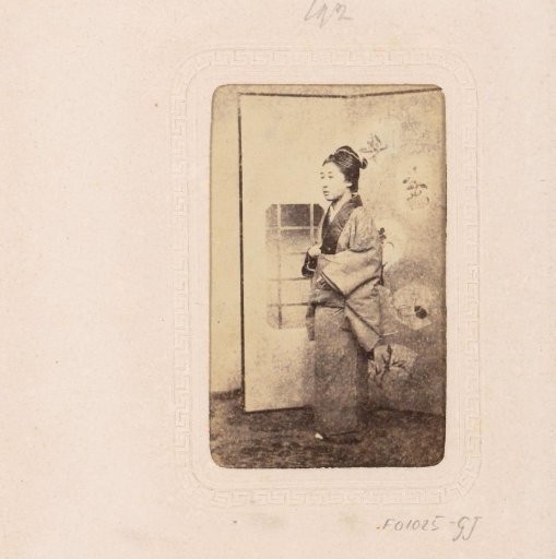 Portrait of a Japanese woman before a room screen