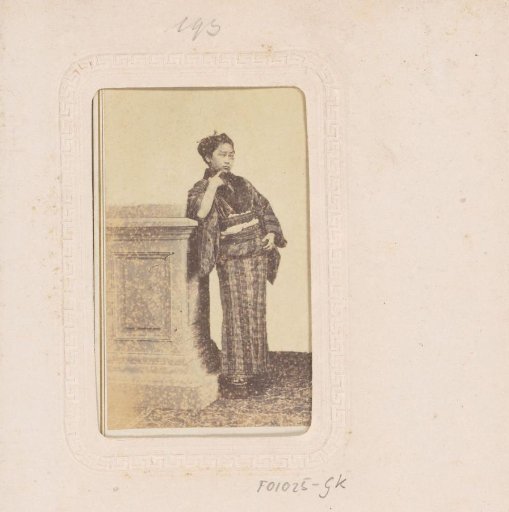 Portrait of a Japanese woman leaning on a pillar