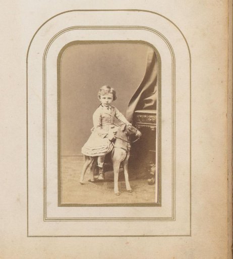 Portrait of a Girl Sitting on a Hobby Horse