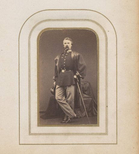 Portrait of a man in uniform with a cap and walking stick
