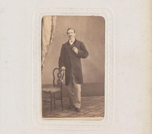 Portrait of a Man with a Cigar Standing by a Chair