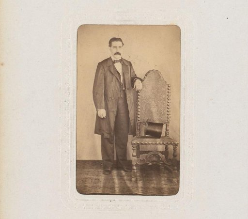 Portrait of a Man Standing by a Chair with a High Hat
