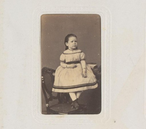 Portrait of a girl standing on a chair