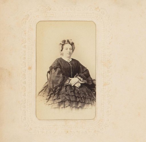 Portrait of a seated woman with a cap
