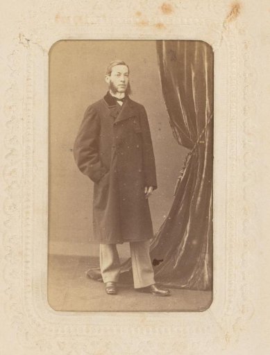 Portrait of a standing man with sideburns