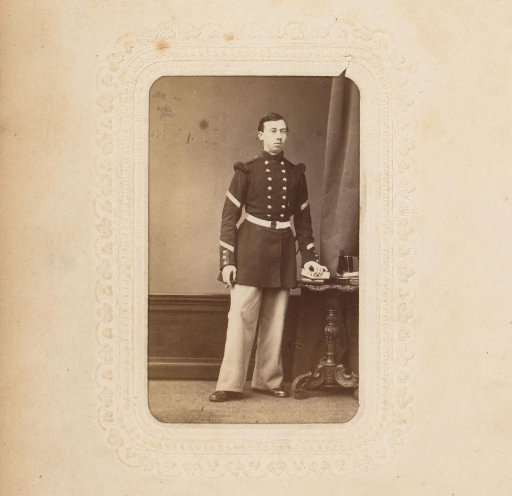 Portrait of a young man in uniform with a cigar and a book