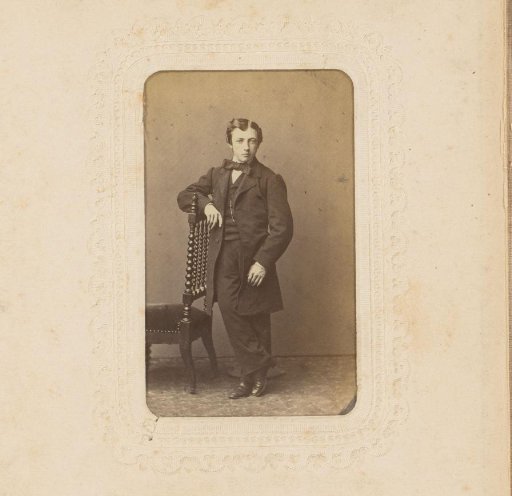 Portrait of a Young Man Standing by a Chair
