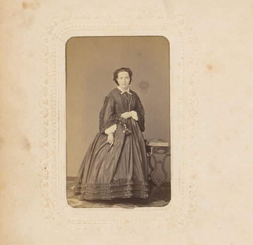 Portrait of a Woman Standing by a Stand with an Album