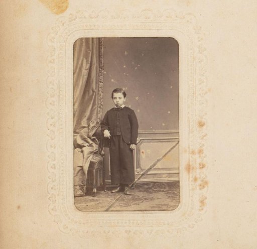 Portrait of a Boy Standing by a Chair