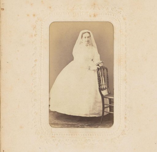 Portrait of a Woman in a White Dress with Veil and Book