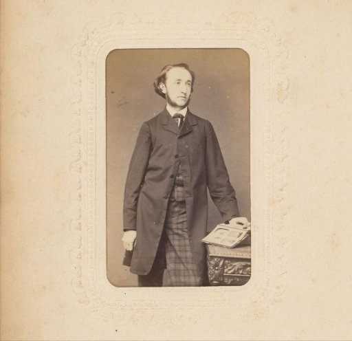 Portrait of a Man with Sideburns and an Open Photo Album