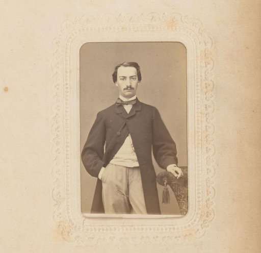 Portrait of a man standing by a chair