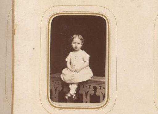 Portrait of a girl, sitting on a balustrade