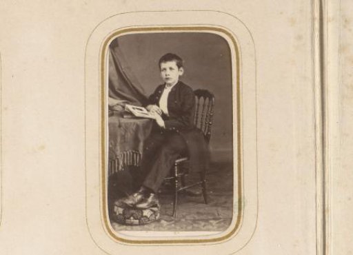 Portrait of a seated boy with a book