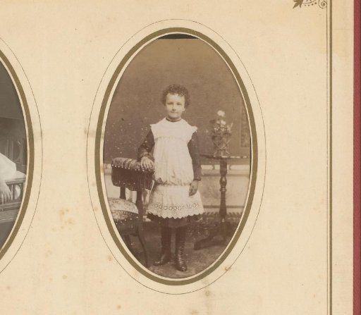 Portrait of a girl standing by a chair