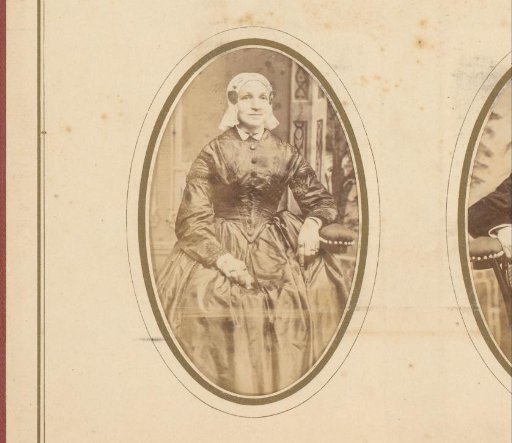 Portrait of a seated woman in a white cap and ear-covers