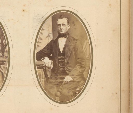 Portrait of a seated man with sideburns