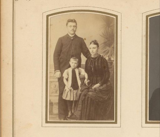Portrait of a standing man, a seated woman, and a standing girl