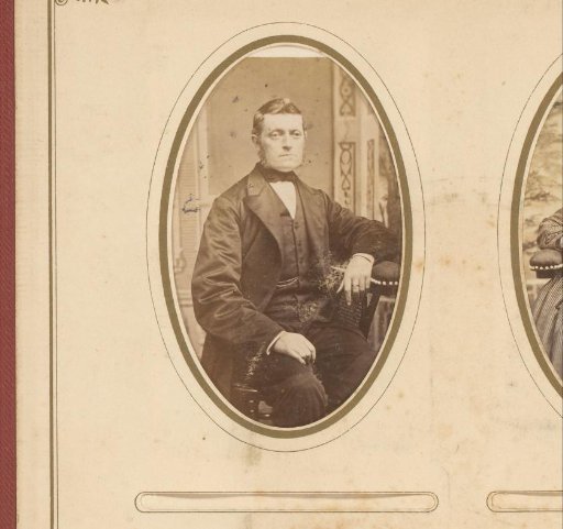 Portrait of a seated man with sideburns
