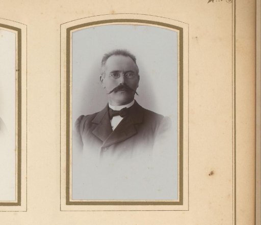 Portrait of a man with a moustache and spectacles