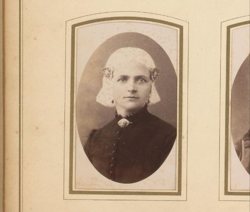 Portrait of a young woman in a white traditional cap and ear-covers