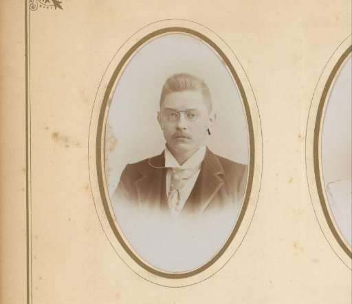 Portrait of a man with a mustache, spectacles, and cravat