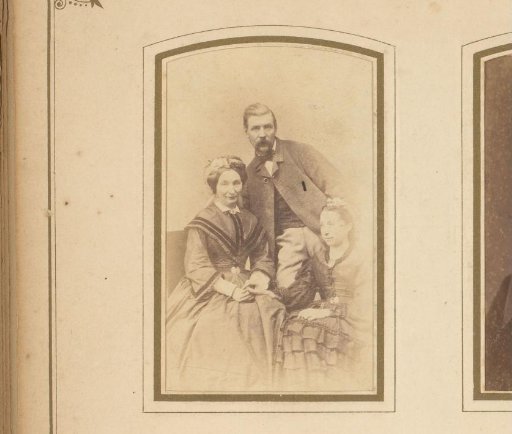 Family portrait of a standing man, a seated woman, and a seated girl