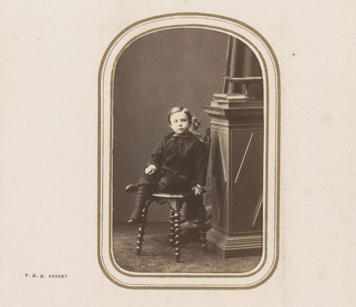 Portrait of a child, seated on a chair
