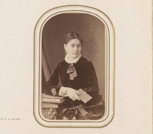 Portrait of a seated young woman with a book in her hand